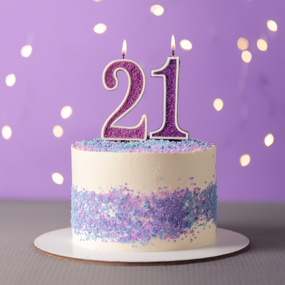 Group of young adults celebrating a 21st birthday with confetti and smiles in a stylish bar